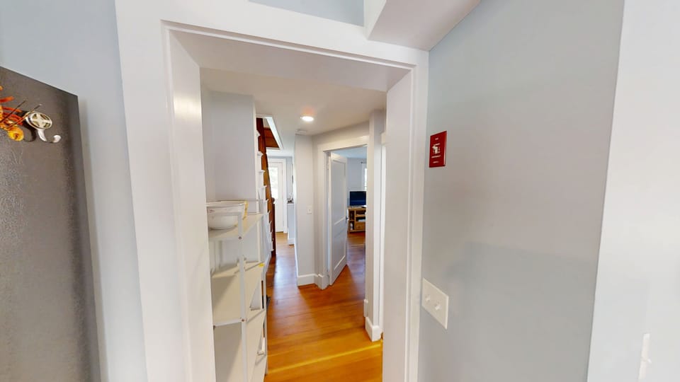 Hallway to first level bedroom and full bath.