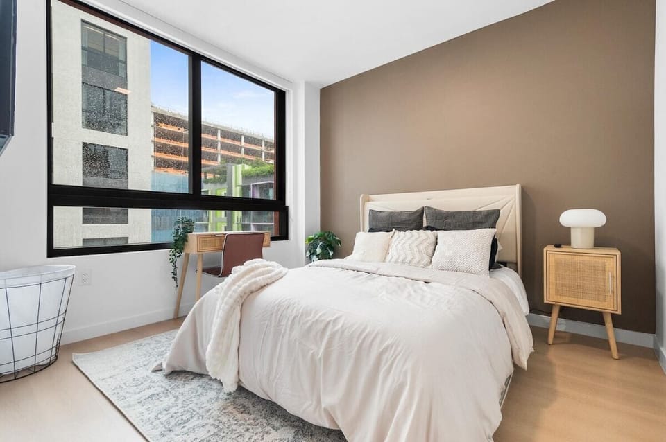 Bedroom with a queen-size bed, and dedicated workspace