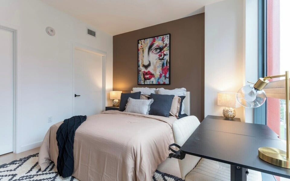 Bedroom with a queen-size bed and dedicated workspace