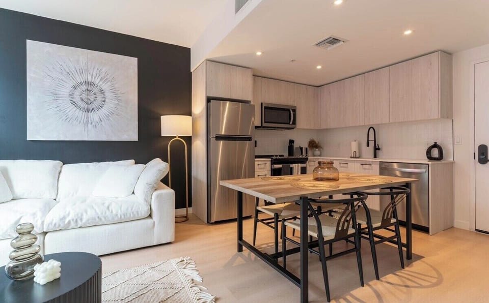 Open-concept layout with dining area, kitchen, and living space