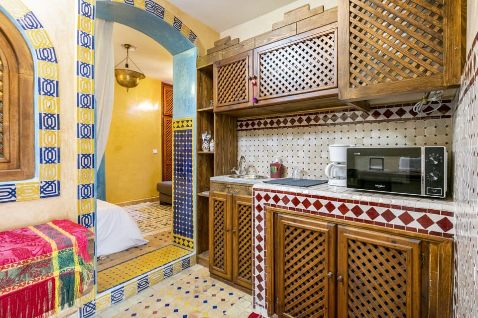 Well-equipped kitchenette with a sink, microwave, and coffee maker, perfect for preparing light meals and beverages during your stay.