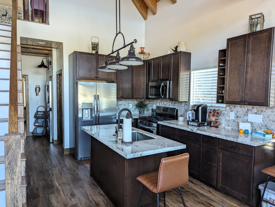 Kitchen has granite counters, large sink and new stainless steel appliances.