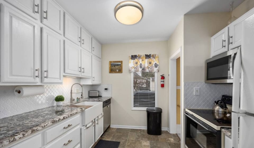 Efficient galley kitchen with beautiful granite countertops.