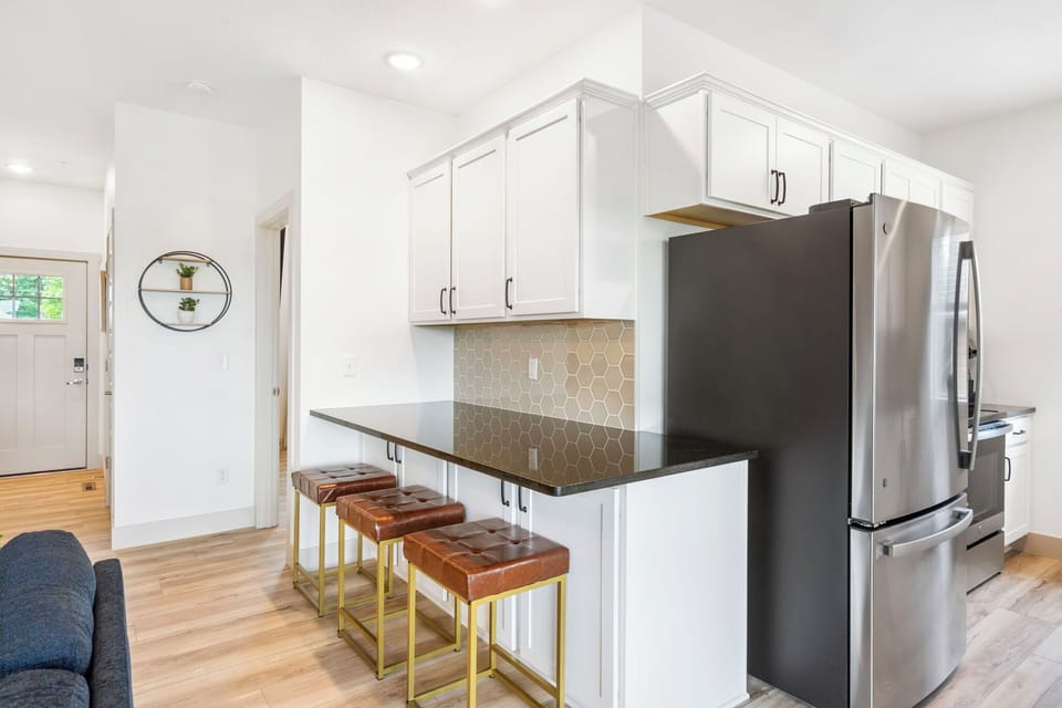 The kitchen bar offers additional seating.