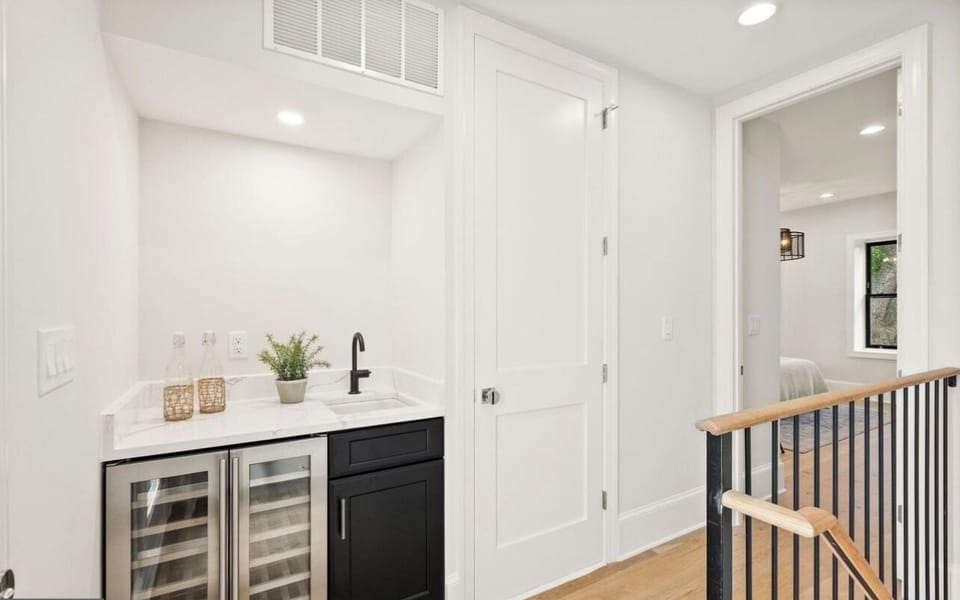 Wine fridge, sink, laundry closet door and master bedroom entrance. 3rd floor.