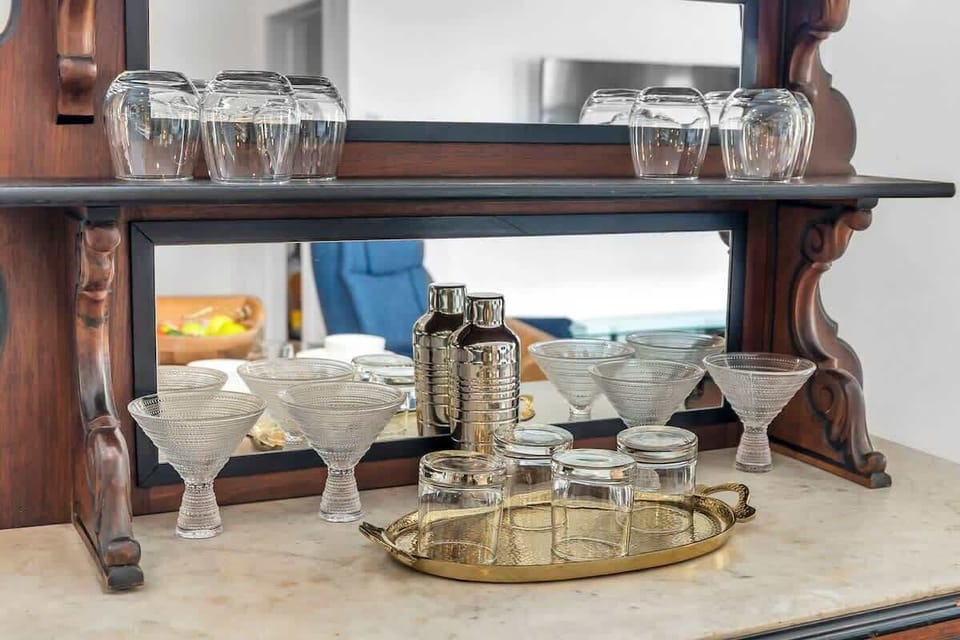 Dining room hutch with cocktail-making utensils and drinkware perfect for unwinding after a day of exploring.