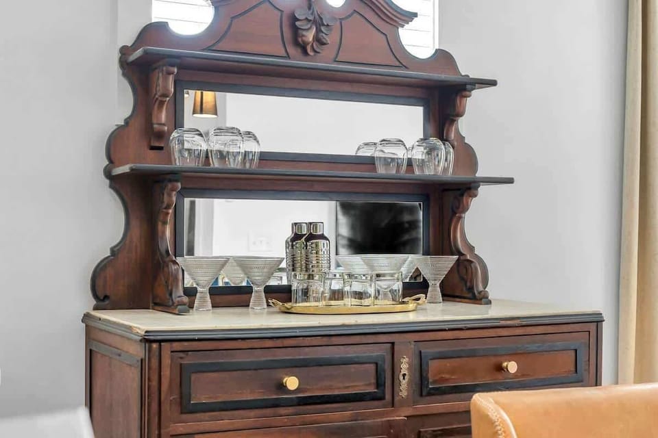 Dining room hutch with cocktail-making utensils and drinkware perfect for unwinding after a day of exploring.