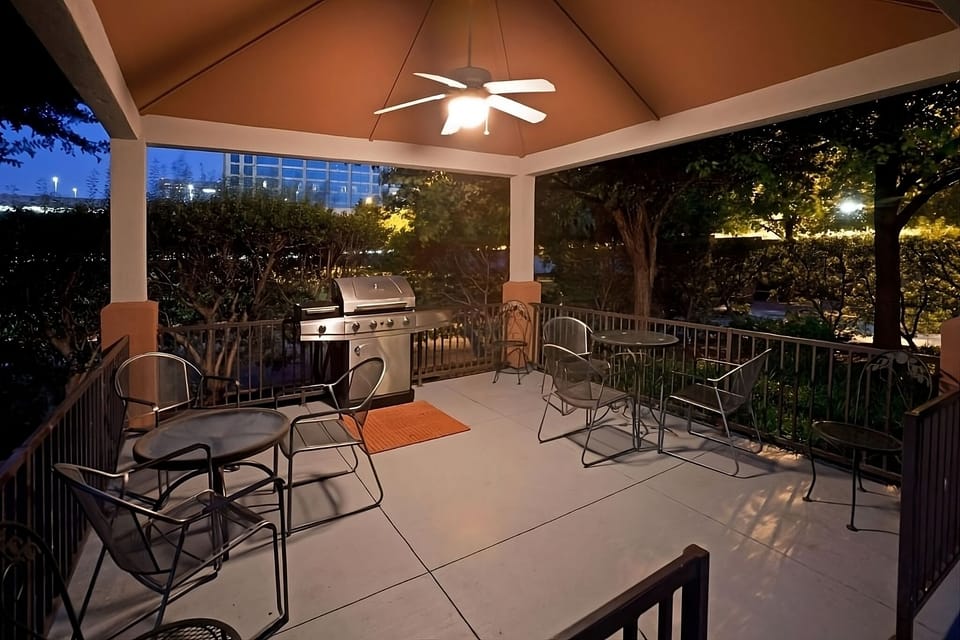 Gather outdoors for evening grilling under a breezy covered patio.