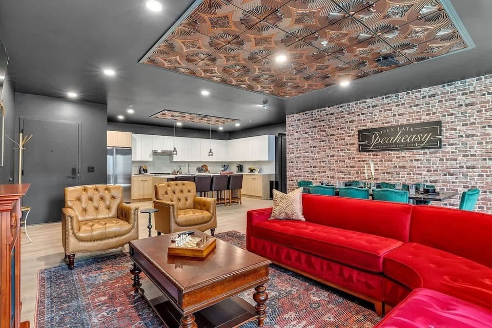 Open-floor living space featuring a smart flat-screen TV and designer furnishings. This inviting area effortlessly connects the dining space with the well-appointed kitchen.