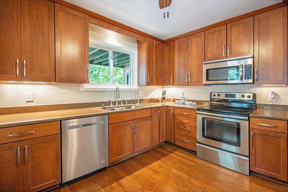 Full kitchen includes stove top, oven, microwave, refrigerator, dishwasher, and access to screened porch