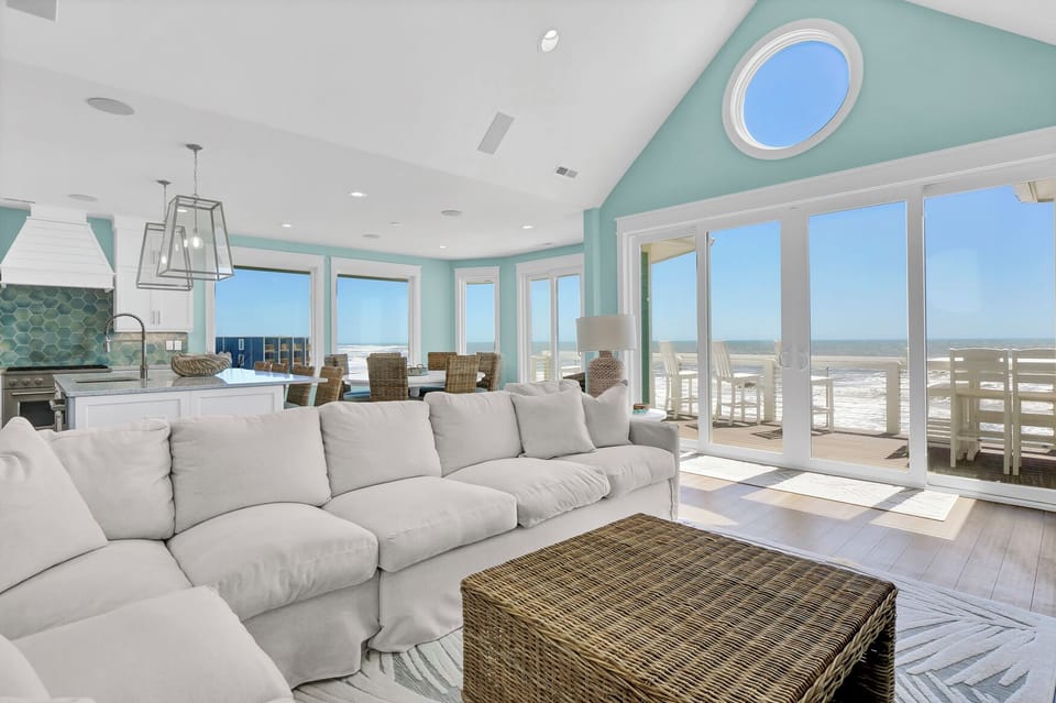 living area that offers plenty of seating with amazing oceanfront views