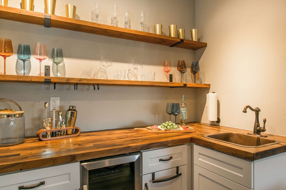 Kitchenette at the living room with cocktail shakers and aesthetic sink
