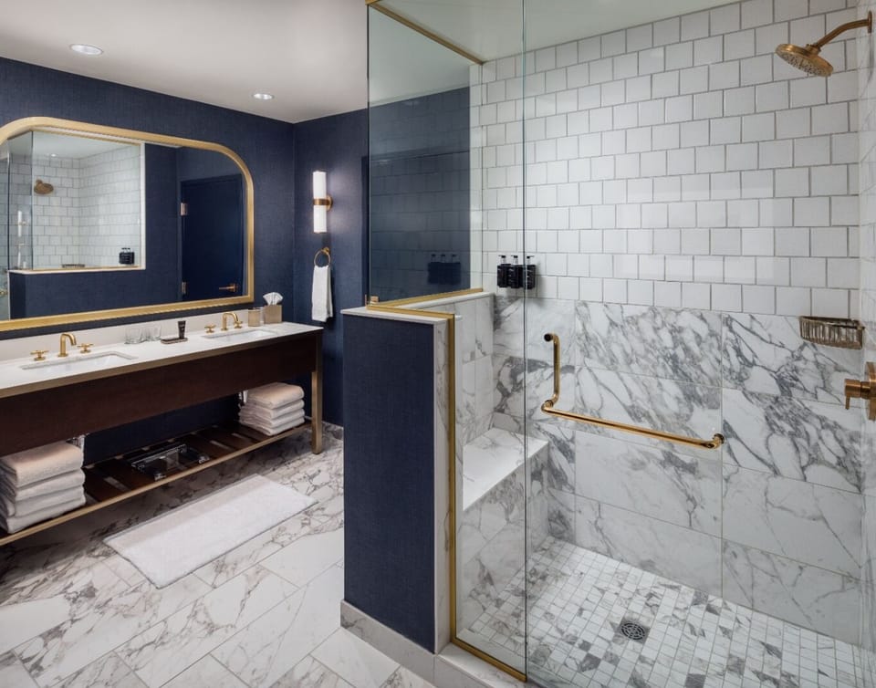 Refresh in a spa-like marble bath with rainfall shower.