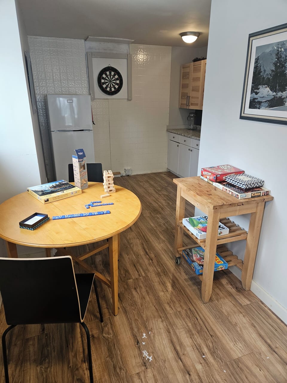 Lower Level with fridge, sink, table chairs, games.