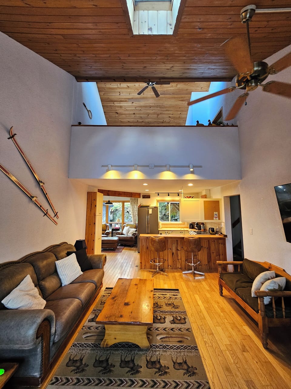 Living Room with Cathedral Ceiling. Loft upstairs, Sofa, Smart TV, Ceiling fan.