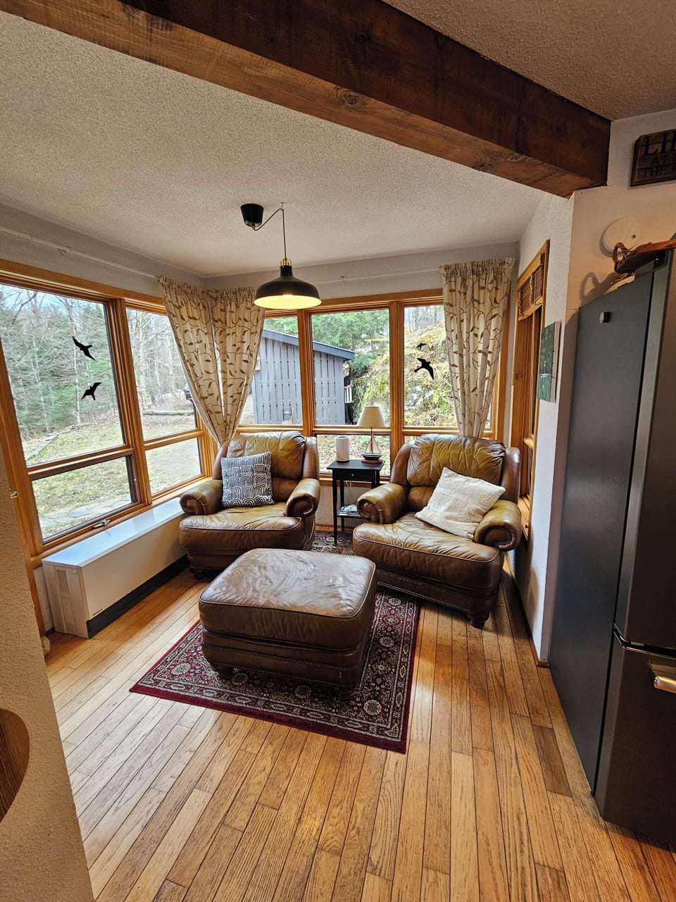 Favorite Reading Space with windows on 3 sides. 2 comfy chairs and ottoman.