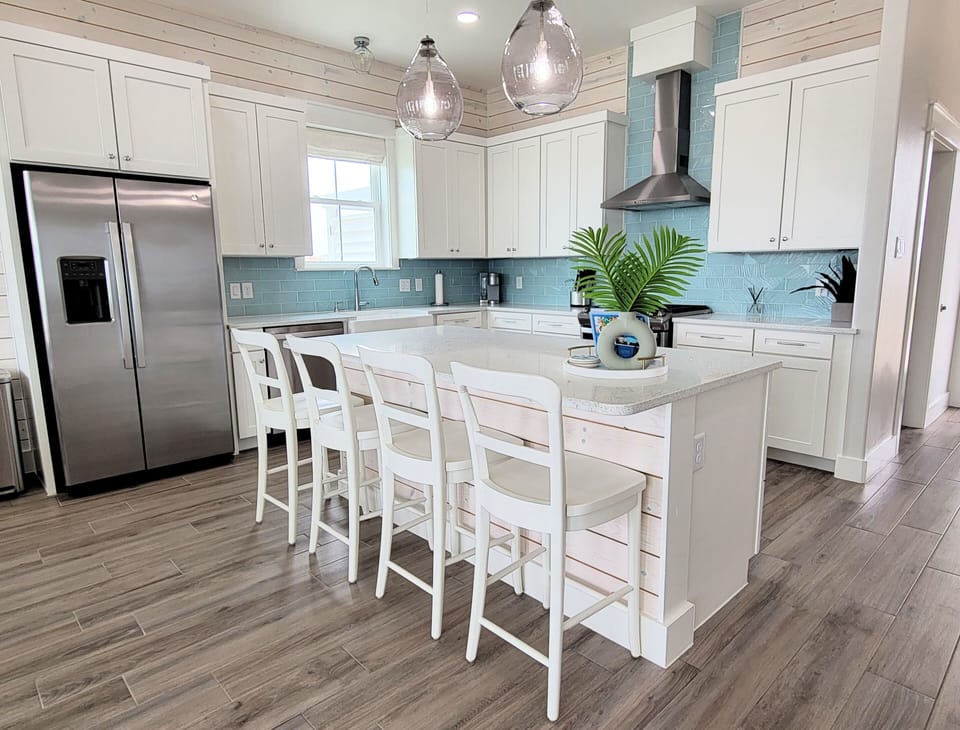 The open kitchen has stainless appliances and grantie counters