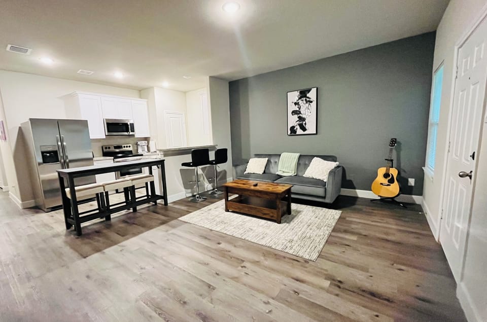 Spacious living room opens kitchen area and bar.  Plush sofa with coffee table