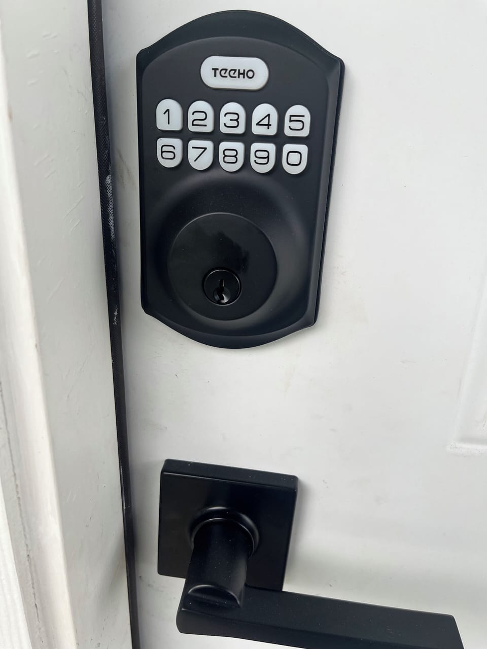 Front door entry equipped with keyless lock for easy access.