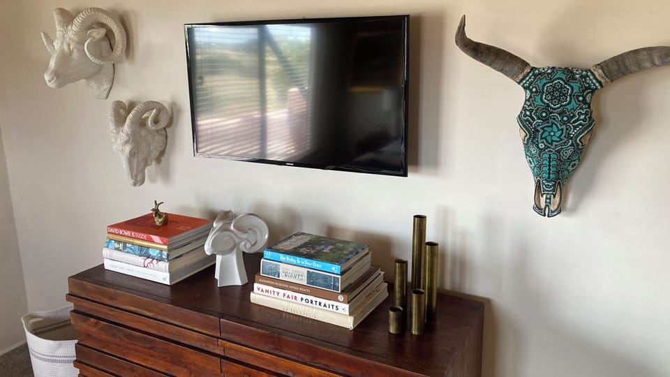 Bedroom smart tv and chest of drawers.