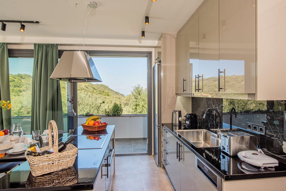 Main villa open plan fully equipped kitchen - dining - living area