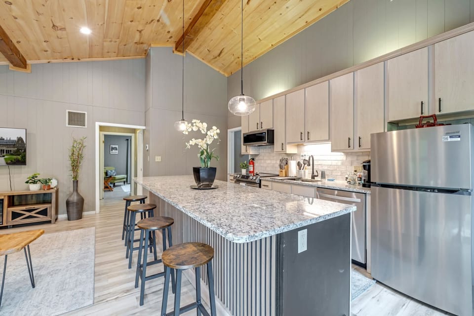 Modern Kitchen: Bright and inviting space with granite counters and charming bar seating!
