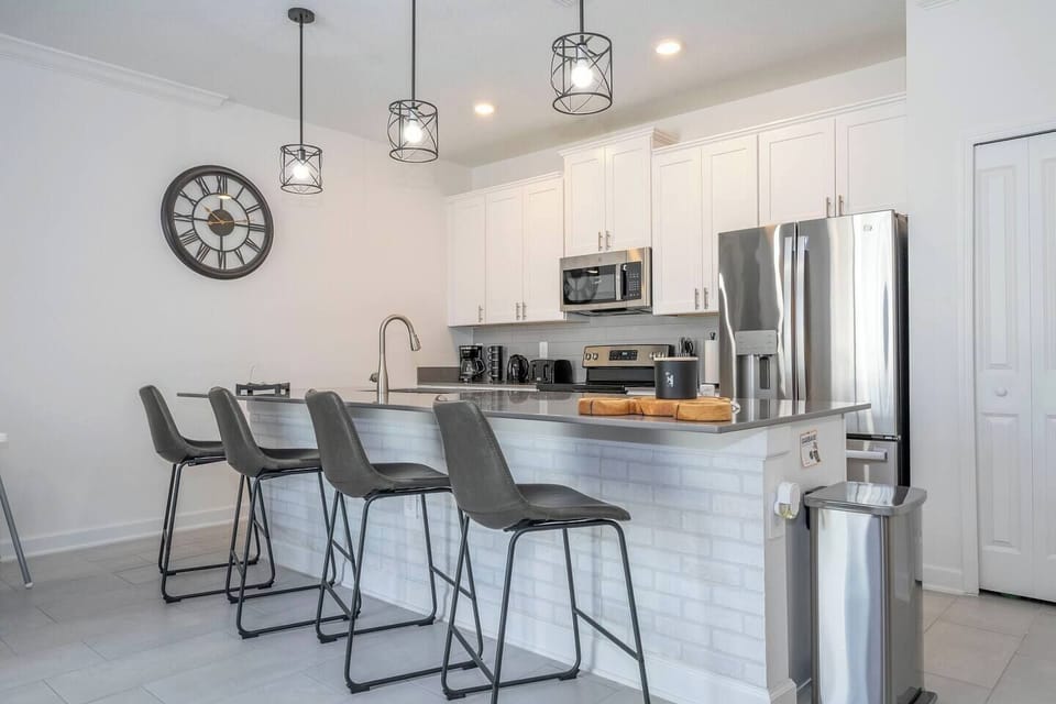The fully equipped kitchen features modern appliances, sleek cabinetry, and all essential cookware and utensils, making it perfect for preparing meals with ease.