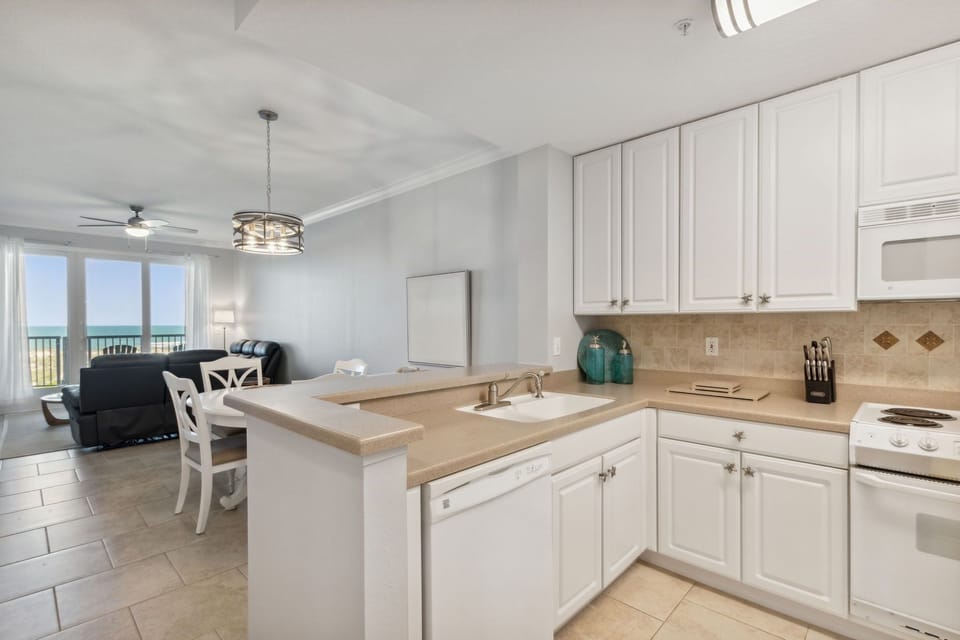 Fully Stocked Kitchen Opens to Living and Dining Areas