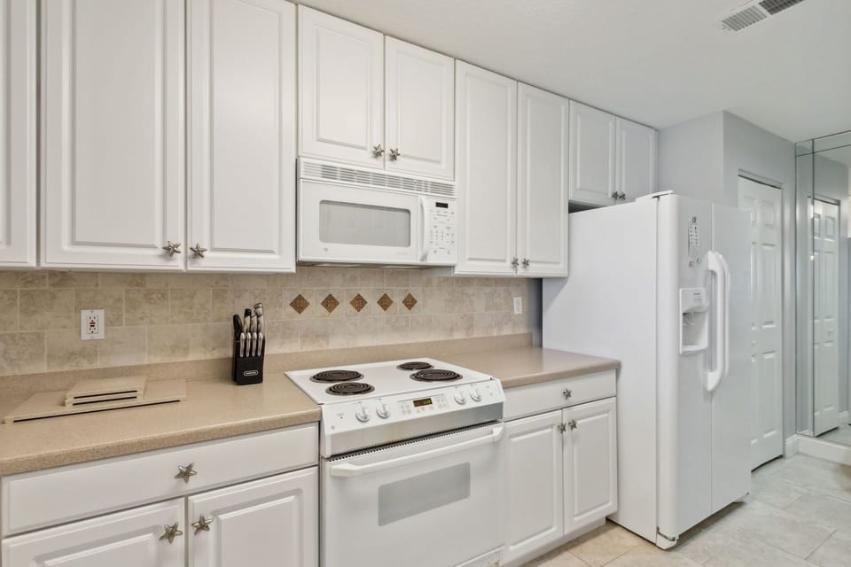Fully Stocked Kitchen Opens to Living and Dining Areas
