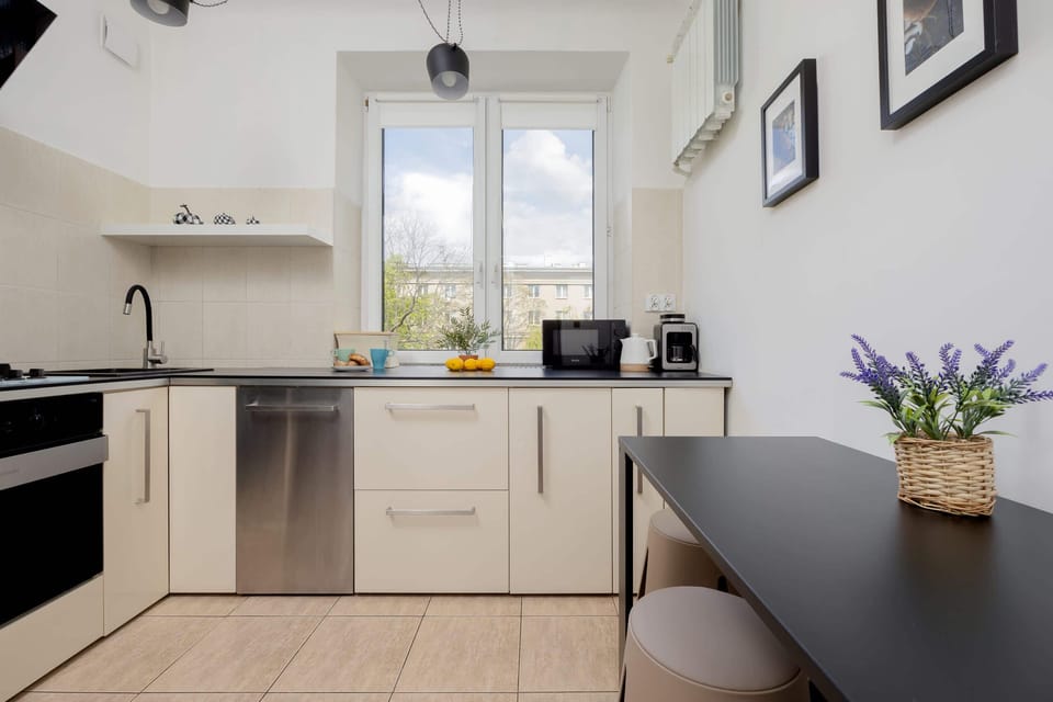 A practical kitchen, equipped with a table and encouraging kitchen exploration.