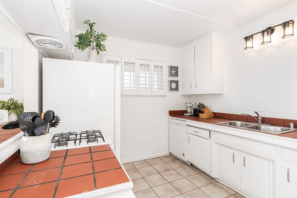 Though small, the efficient kitchen in this beachfront property is where you can prepare your delights while still enjoying panoramic ocean views.
                