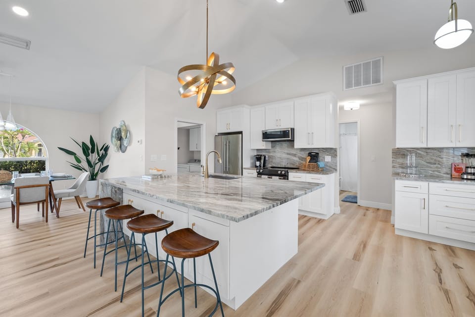 Our fully-equipped kitchen features ample seating around the island, perfect for casual breakfasts or entertaining while you cook.