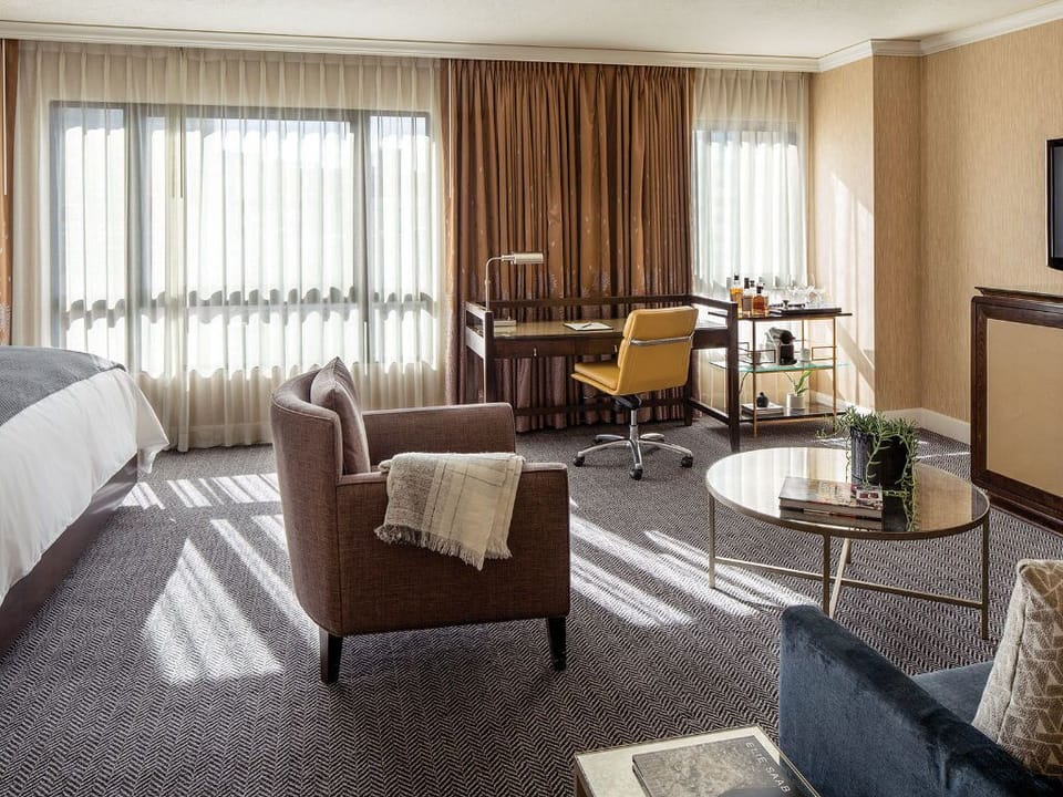 A spacious lounge area with a view, where elegance and comfort create an inviting urban oasis.