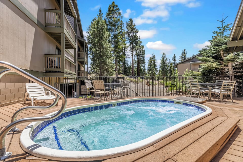 Unwind in the hot tub 🔥 with serene forest views 🌲 after mountain adventures