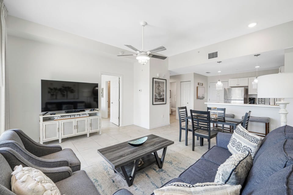 Livingroom has a comfy sofa bed and ceiling fan