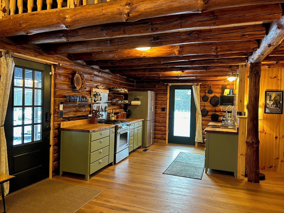 Roomy full kitchen with custom cabinetry (live edge ash countertops).