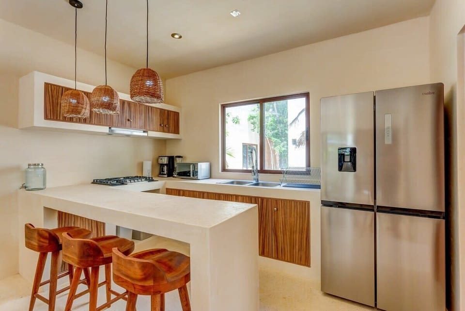 A fully equipped kitchen with quality appliances is nearby for preparing meals at home