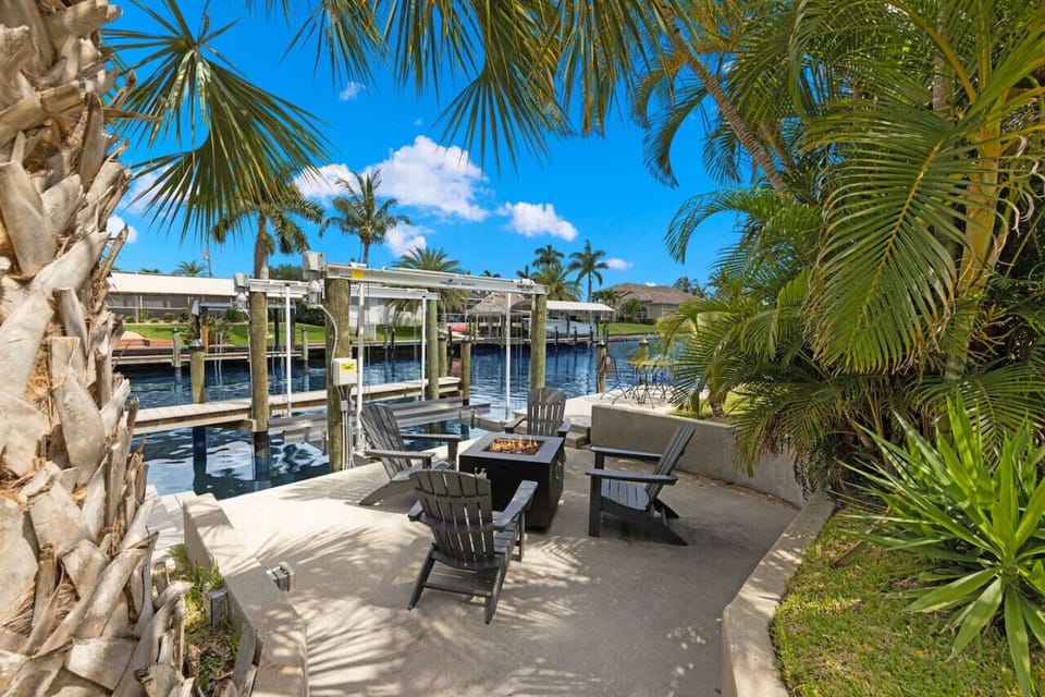 Unwind by the gas firepit, nestled beside the dock in a lush tropical setting—perfect for cozy evenings with stunning water views.
