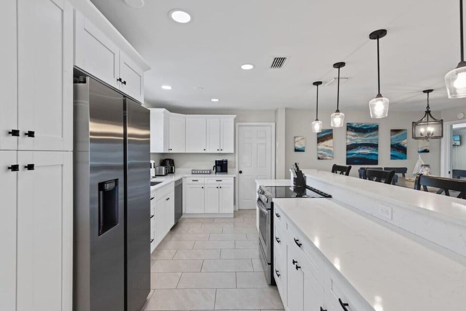 Cook in style in this modern white kitchen, complete with a Keurig and complimentary K-cups for your morning brew or afternoon pick-me-up.