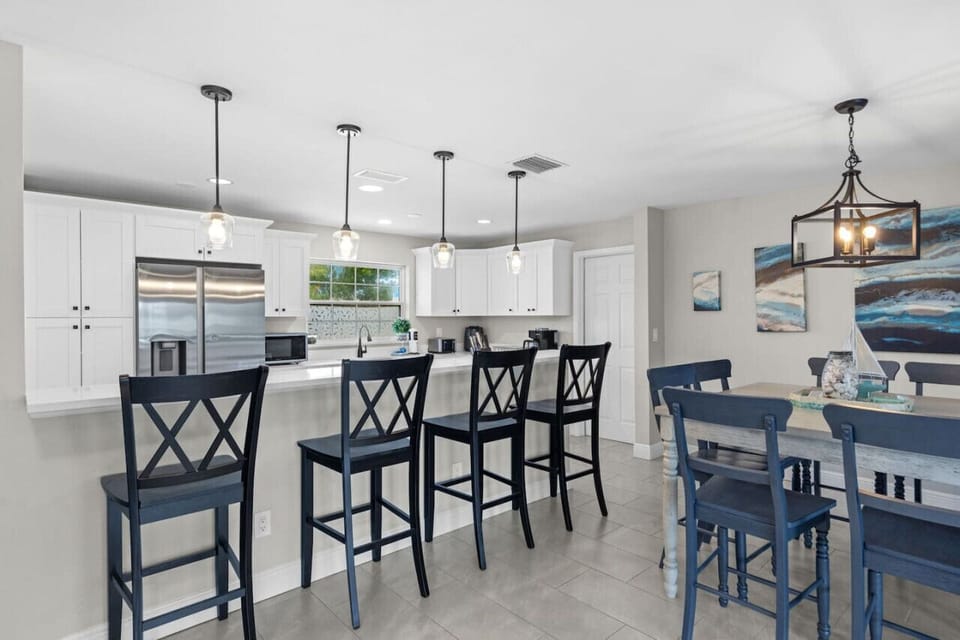 Dinning area with four barstools  and table for eight