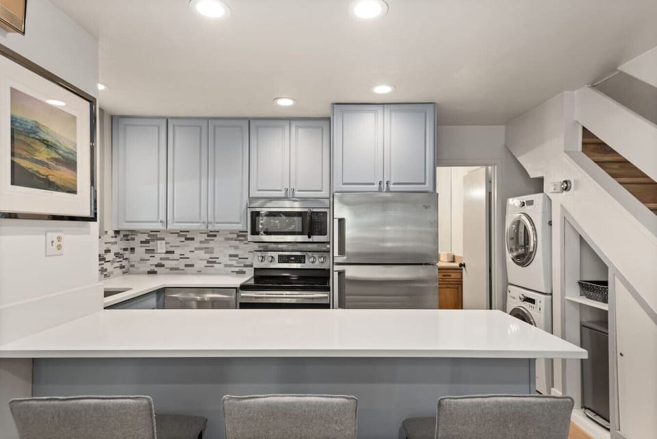 Modern kitchen with stainless steel appliances and stone countertops