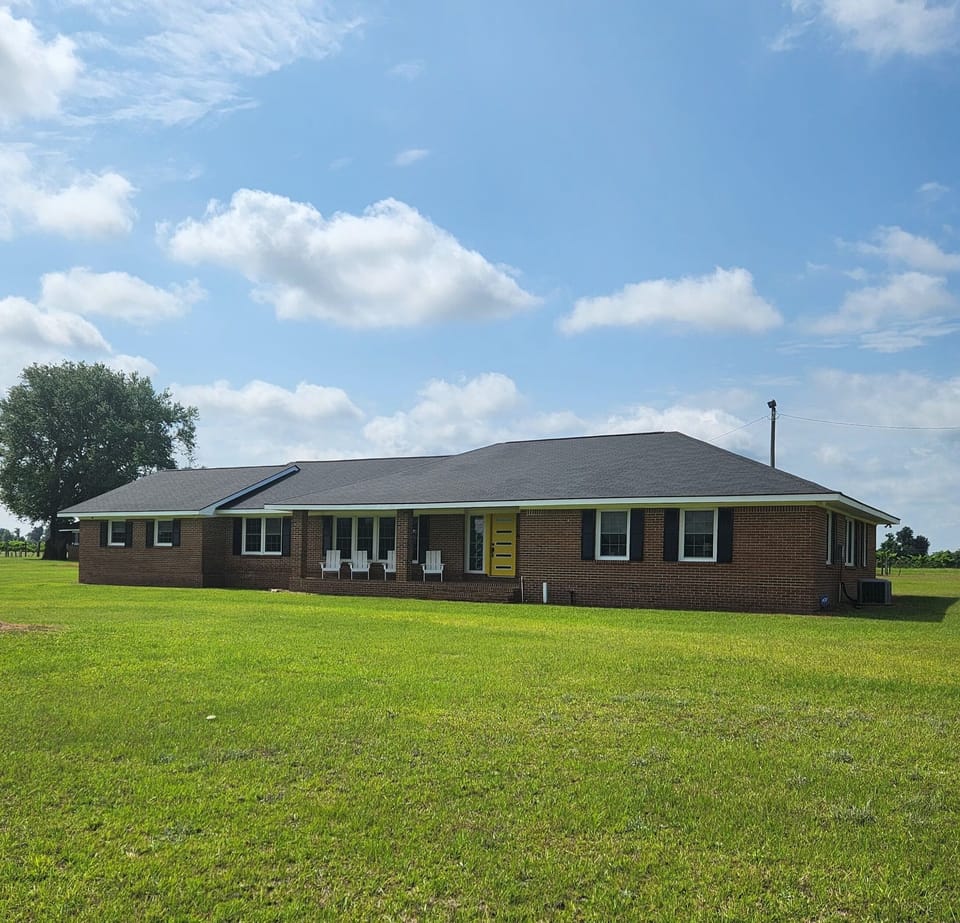Front of property with four Adirondack chairs, cushions in laundry room.