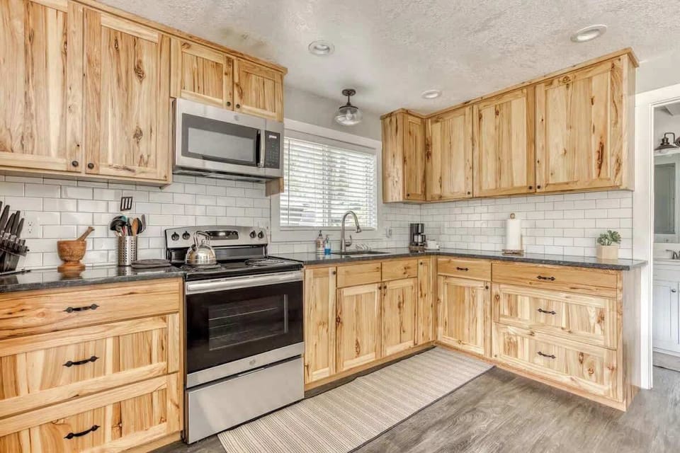 Bright and rustic kitchen with hickory cabinets, subway tile, and stainless appliances—perfect for cooking and cozy gatherings.