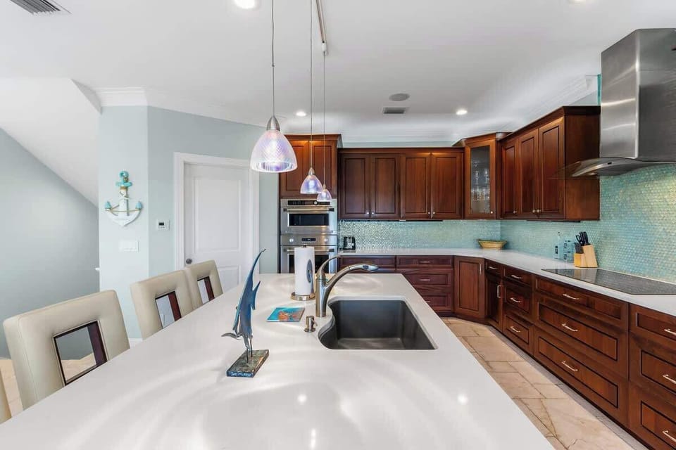 Large open kitchen with bar seating for 3