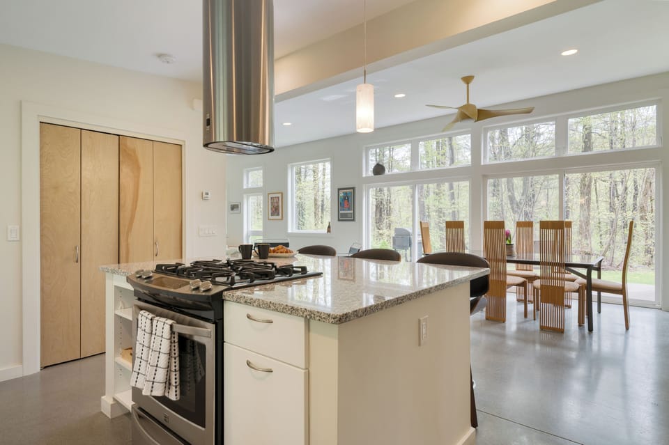 Fully equipped kitchen with stainless steel appliances and a gas range.