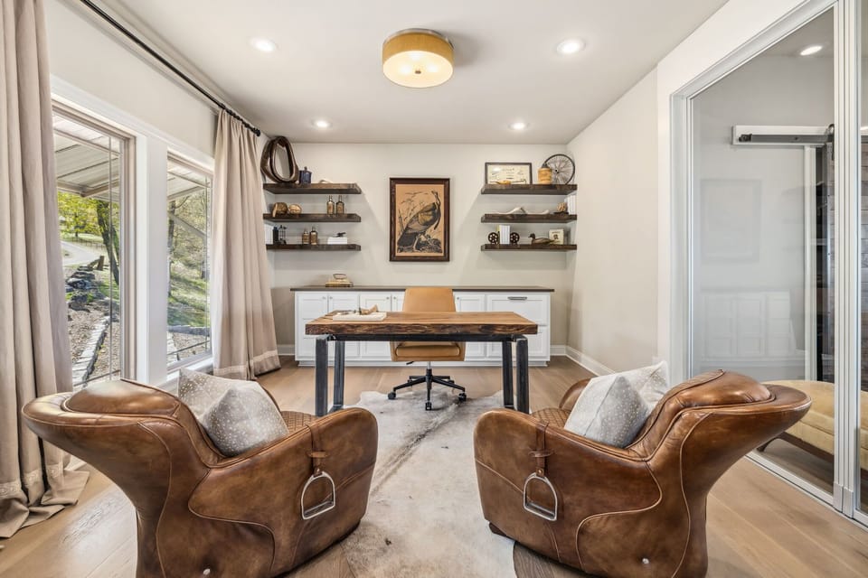 The office features a desk, chairs, and a Bluetooth keyboard, mouse and printer.