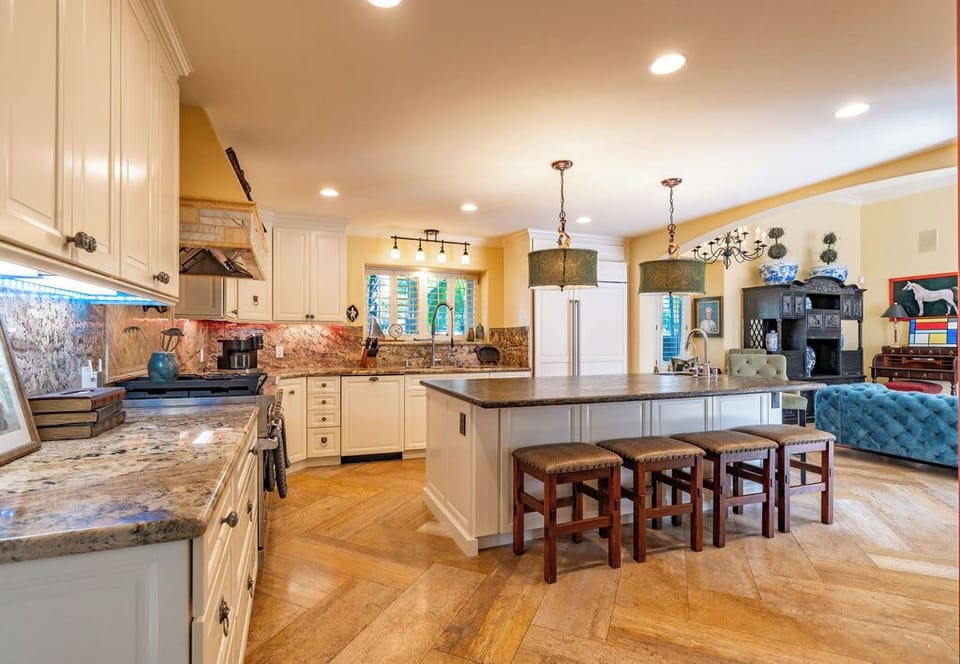 Savor the joy of cooking in our gourmet kitchen while remaining close to family in the adjacent family room, ensuring every meal is a shared experience filled with warmth and laughter.