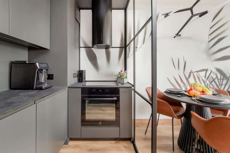 The kitchenette with modern appliances and wooden accents combines functionality with aesthetics.