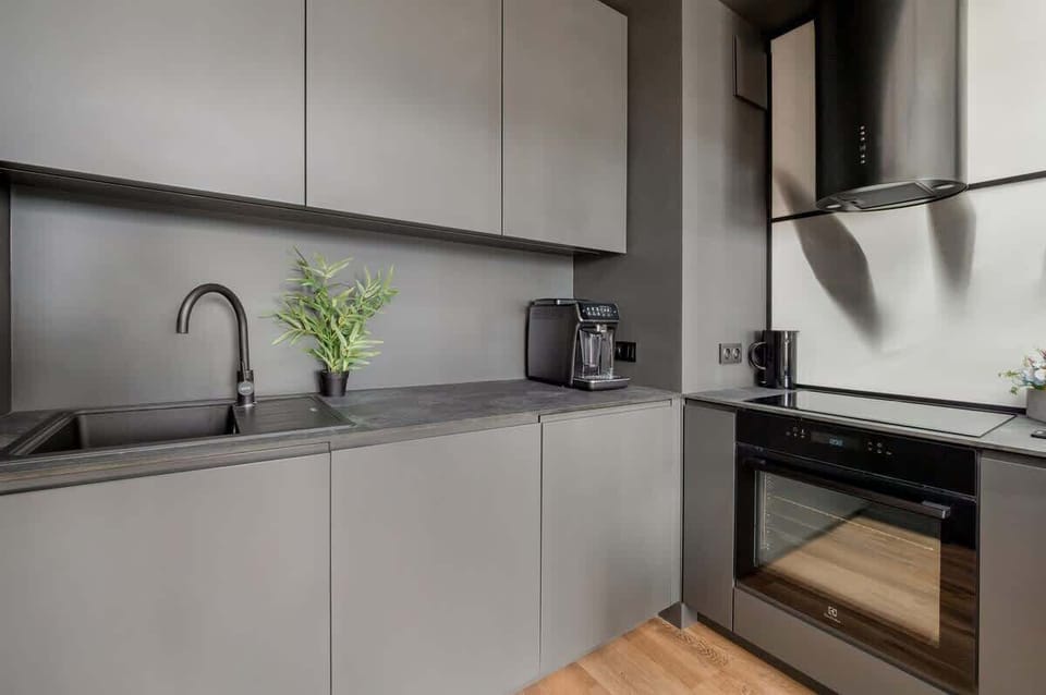 The kitchenette with stainless steel appliances and minimalist design is elegant and practical.