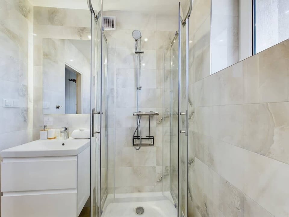Pristine bathroom with a large shower and premium finishes.

